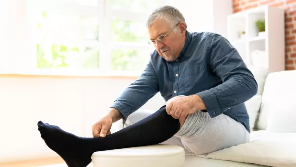 Man putting on compression stockings