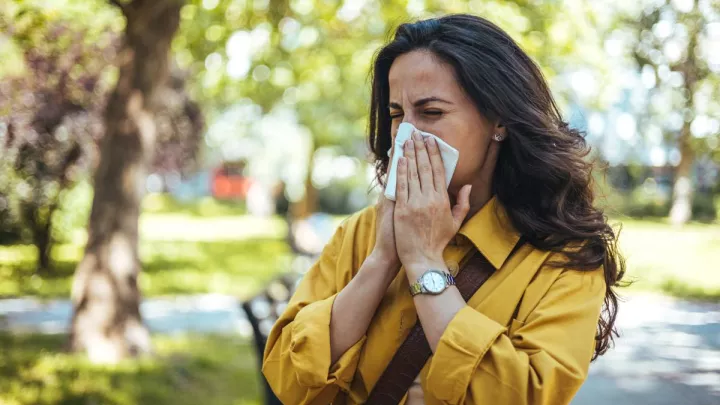 Woman blowing her nose