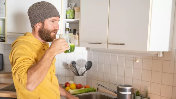 Man drinking green juice