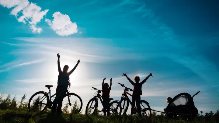silhouetted cyclists
