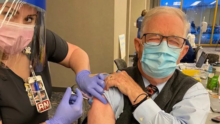 Ward Chambers, MD, receiving his COVID-19 vaccine