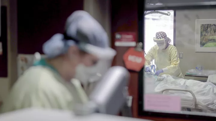 Nurses in full personal protective equipment treat COVID-19 patients at Nebraska Medical Center.