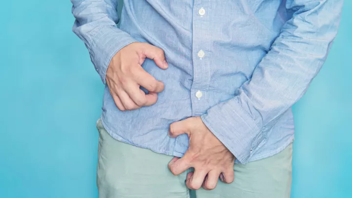 Close up of man itching groin