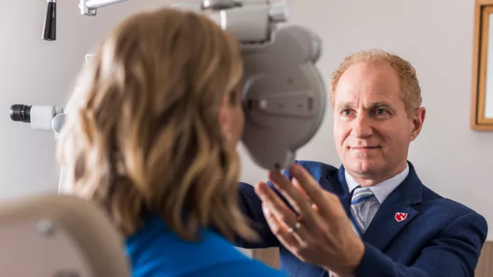 Ronald Krueger, MD, ophthalmologist, with patient
