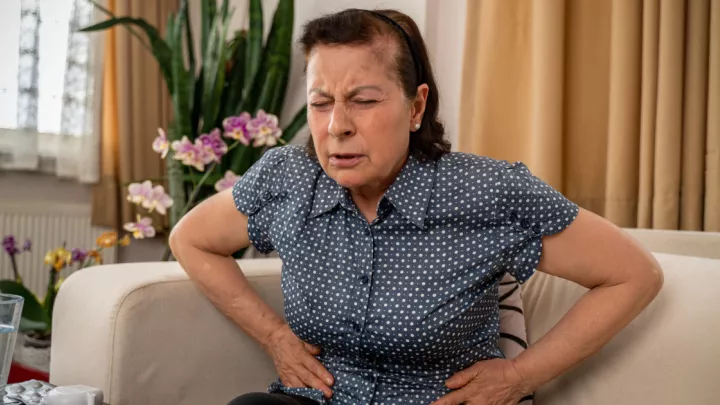 Woman holding stomach in pain