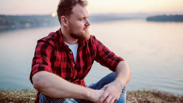 Man sitting by lake