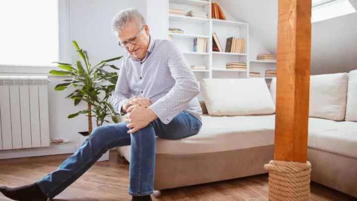 Man holding his knee in pain