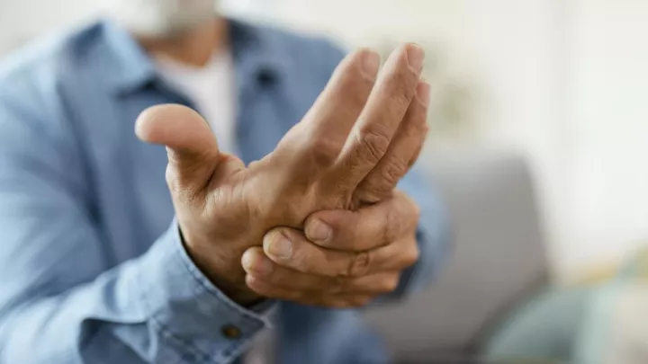 Close up of man holding his hand