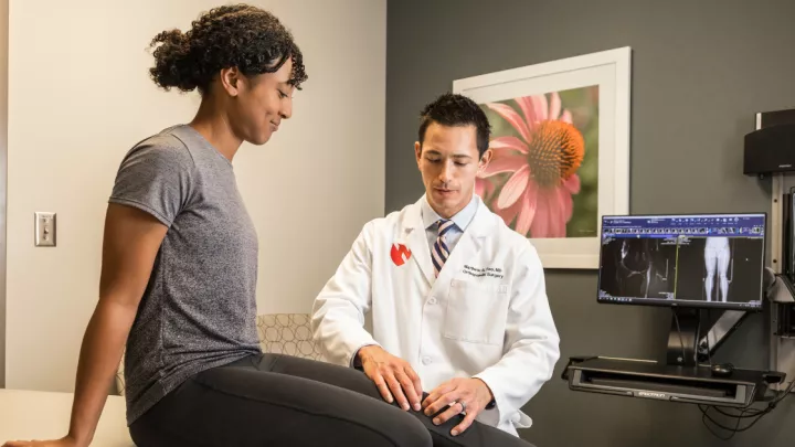 Dr. Tao evaluating patient's knee