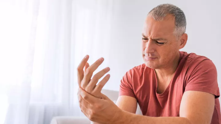 Man holding his hand in pain