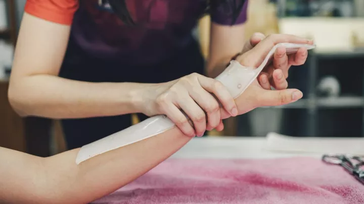 Therapist adjusting patient's hand