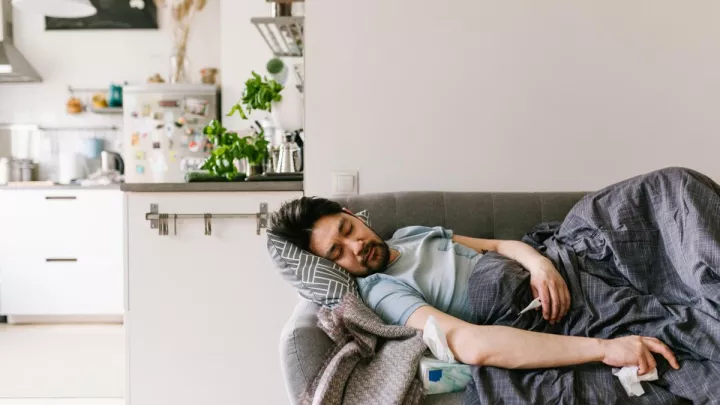 Man lying sick on the couch