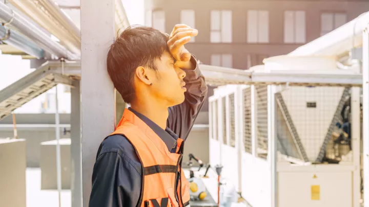 Construction worker holding his head