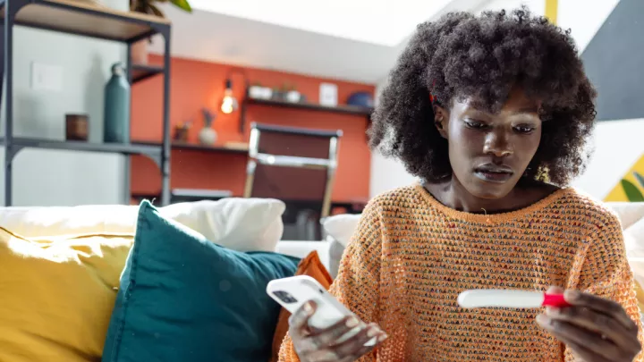 woman looking at pregnancy test