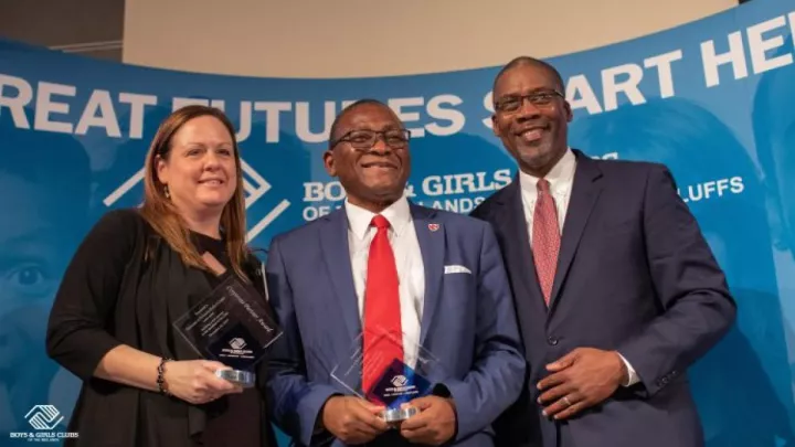 Charity Evans, MD, and Dele Davies, MD (center), received the Corporate Partner Award from the Boys &amp; Girls Club of the Midlands.