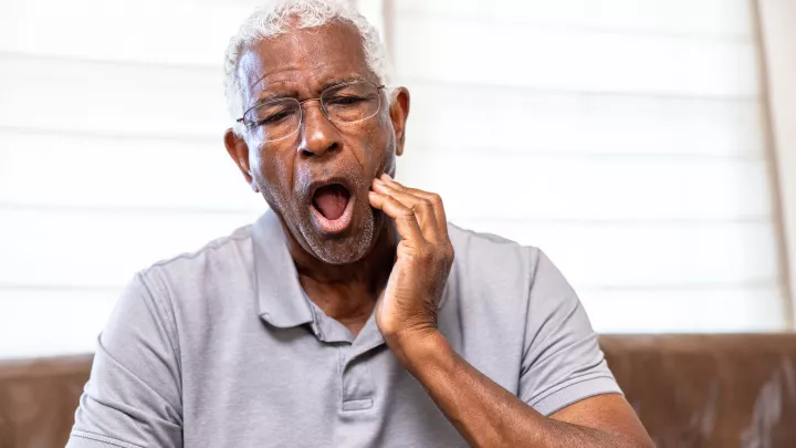 Man holding his jaw in pain