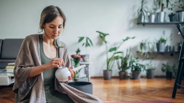 Woman holding neti pot