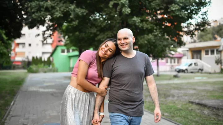 Male cancer patient walking with woman