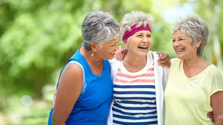 Three older women hugging