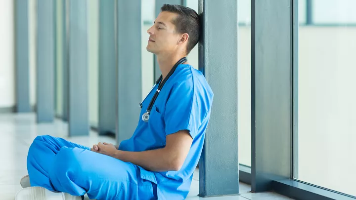 Male nurse sitting on floor
