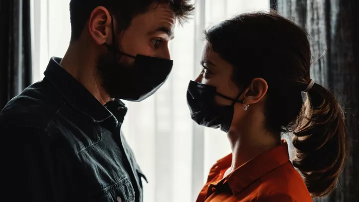 Man and woman wearing masks