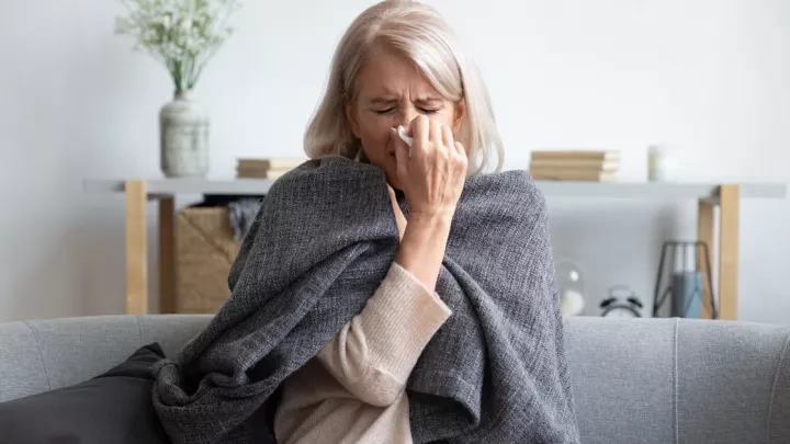 Woman blowing her nose
