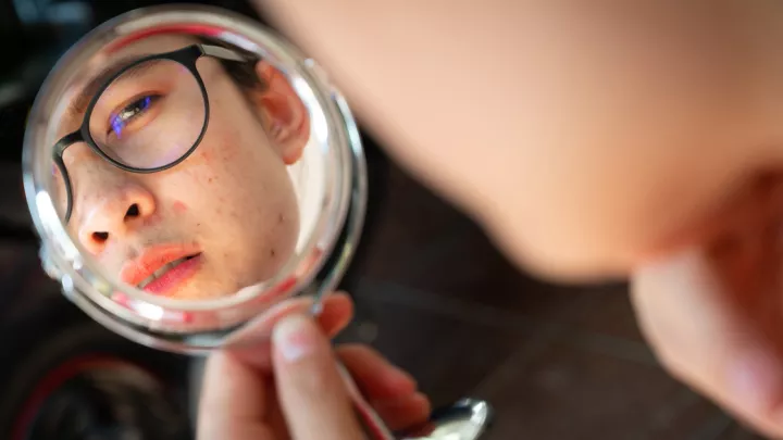 Teen boy looking in mirror