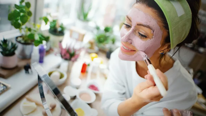 Woman putting on a face mask