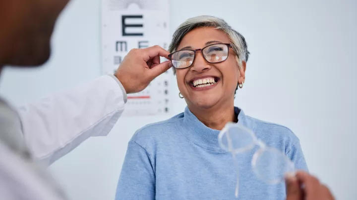 Older woman trying on eyeglasses