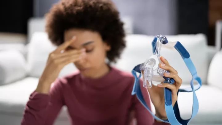 Woman holding CPAP mask