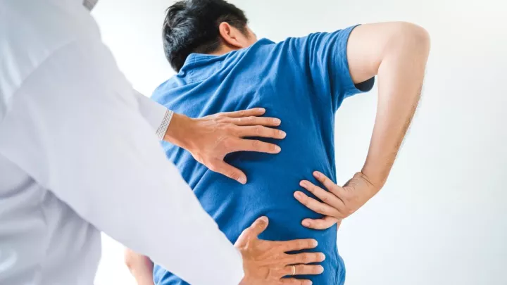 Doctor examining man's back