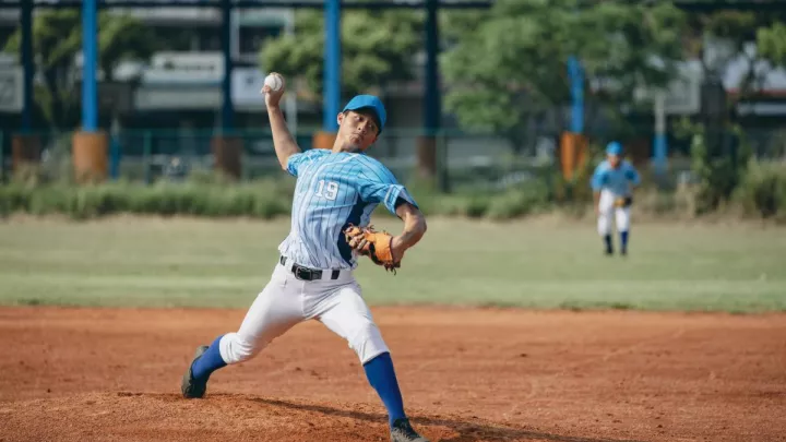 Teen boy pitching