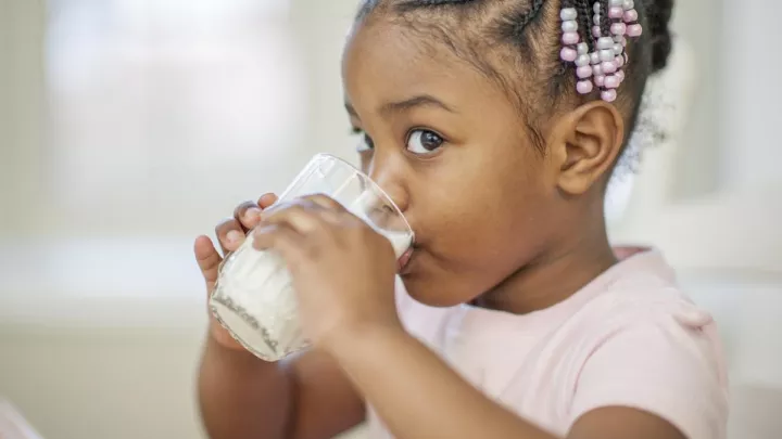 Young girl drinking milk