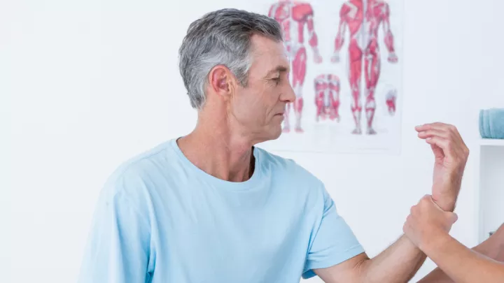 Man getting his hand examined