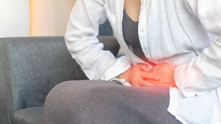 Woman grabbing her abdomen in pain