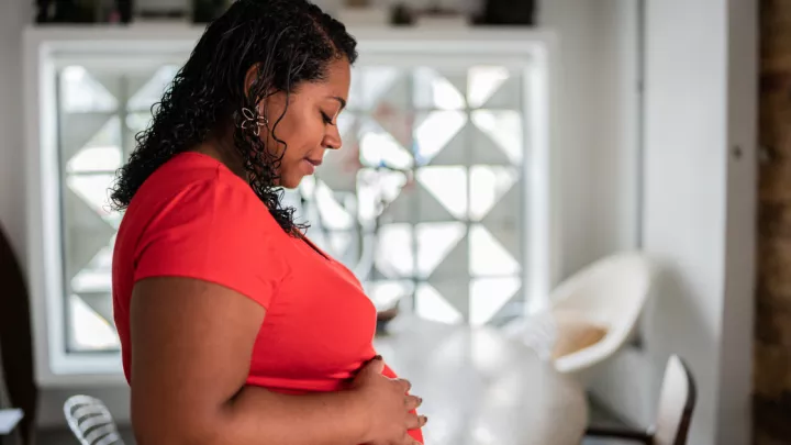 Pregnant woman touching her stomach