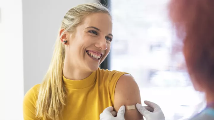 Smiling woman getting her flu shot