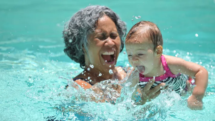 Grandmother and granddaughter swimming