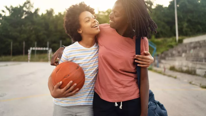 Mom picking up teen daughter from basketball practice