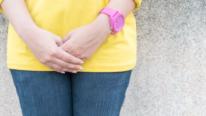 Woman holding her hands in front of her waist