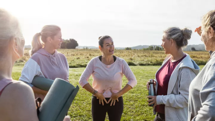 Group of women holding yoga mats